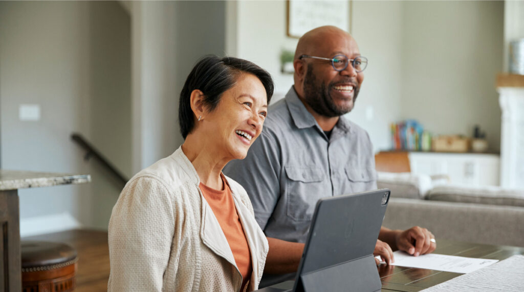 Resident and HOA board member reviewing information together on a tablet