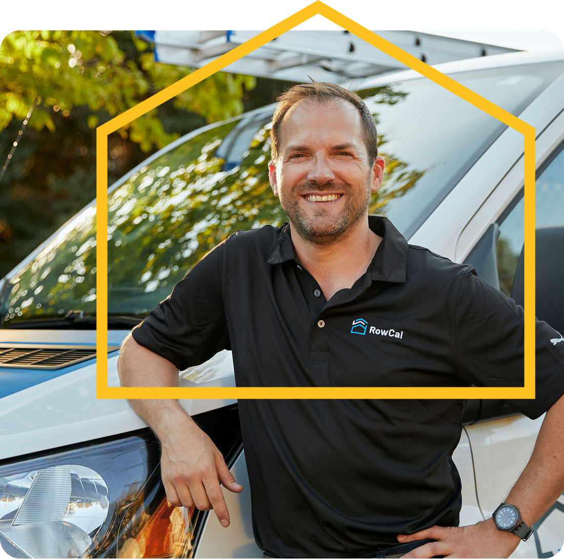 Rowcal property manager standing outside a service vehicle