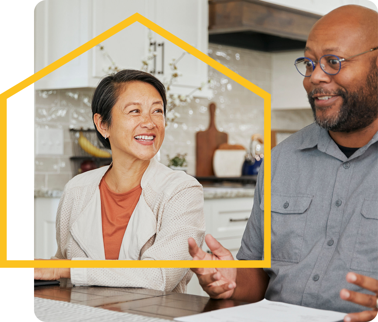 HOA board member smiling while reviewing documents with a resident indoors