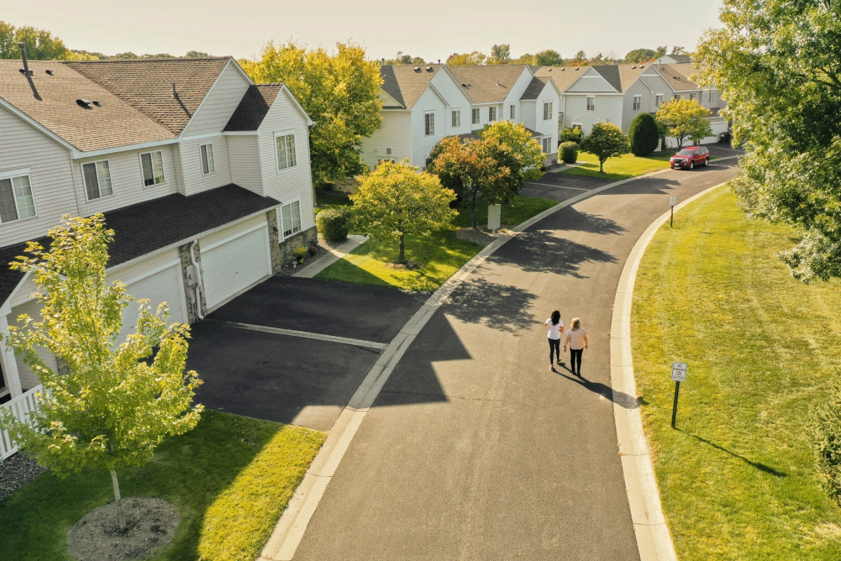 RowCal property manager and HOA board member walking in a Minnesota residential neighborhood.